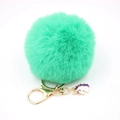 Detail of mint green faux fur pompom keychain with golden clip and unicorn charm - Small Unicorn Keychain / Grass Green