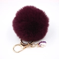Detail of deep purple fluffy faux fur pompom keychain with gold unicorn charm pendant - Small Unicorn Keychain / Fuschia