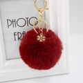 Deep red plush pompom keychain with golden snowflake charm and metal lobster clasp - Burgundy