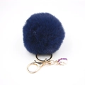 Detail of fluffy dark blue fur pompom keychain with golden unicorn enamel pendant charm - Small Unicorn Keychain / Navy Blue