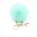 Close-up of mint green faux fur pompom keychain with golden clip and unicorn charm - Small Unicorn Keychain / Mint Green