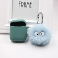 Dettaglio custodia in silicone verde acqua con portachiavi a pompon in peluche azzurro - Azzurro