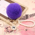 Detail of purple faux rabbit fur pom pom with pearl chain and golden bow charm - Pearl Bowknot / Deep purple