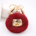 Detail of red faux fur bull plush keychain with golden horns and nose ring accent - Gold Keychain / Burgundy