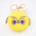 Porte-clés pompon chouette en fausse fourrure jaune avec ailes dorées et yeux bleus - Porte-clés Doré / Jaune