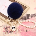 Navy blue faux rabbit fur pompom keychain with pearl chain and bow charm detail - Pearl Bowknot / Navy Blue
