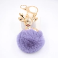 Close-up of golden deer head pendant with fluffy purple faux fur pompom keychain - Violet