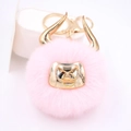 Close-up of pink faux fur bull keychain with golden horns and metallic lobster clasp - Gold Keychain / Light Pink