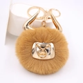 Detail of creative bull plush keychain with gold bull horns and metal lobster clasp - Gold Keychain / Coffee