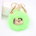 Detailed close-up of a neon green plush bull keychain with golden horns and metallic nose ring - Gold Keychain / Fluorescent Green