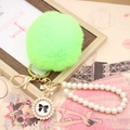 Detail of lime green faux rabbit fur keychain with pearl strap and bow pendant décor - Pearl Bowknot / Fluorescent Green