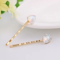 Detail view of gold alloy hairpins featuring colorful AB crystal geometric triangles - Iridescent White