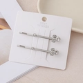 Detail view of silver alloy hair clips with sparkling crystals on a display card - Silver Bowknot