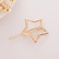 Elegant gold star hair clip with white rhinestones on a minimalist background - Pentagram