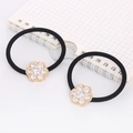 Close-up of two black high-elastic hair ties with sparkling zircon flower charms on white paper - Round Flower (Gold)