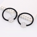 Close-up of black elastic hair ties with sparkling zircon flower charms on a notebook - Round Flower (Silver)
