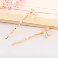 Detail of elegant gold wave hairpins with crystal bow tie and zircon stone accents - Bowknot (Gold)