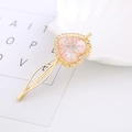 Detailed close-up of a golden heart-shaped hairpin with embedded pink dried flowers - Heart 2