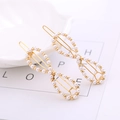 Elegant pair of infinity shaped hair clips with white pearls on a gold metal base - Eight-shape