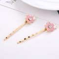 Barrettes à cheveux fleurs de cerisier dorées avec émail rose et cristaux brillants - Style Aile de Fleur de Cerisier