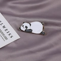 Macro shot of an adorable enamel panda hair clip with gold edges on purple silk fabric - Panda Hair Clip