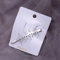 Silver alloy hair clip with tribal flame design on white display card with purple mesh - Linked Darts Silver Pair