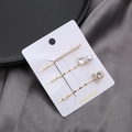 Goldenes Haarklammer-Set mit Kunstperlen, Strasssteinen und Schleife auf Display-Karte - Perlenstab mit Perlenbogen Strass Set