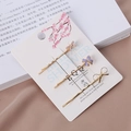 Lot de trois pinces à cheveux dorées avec nœuds en émail violet sur carte cadeau - Ensemble / Violet