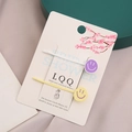 Juego de dos lindas horquillas para el pelo con caritas en tarjeta decorativa - Amarillo Y Blanco Roto Sonriente