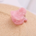 Detailed view of light pink heart hair claw clip with marble acetate texture on cork - Rose Red