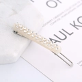 Detail of beige acetate hair clip featuring double-row rhinestone inlay and metal snap - Rhinestone / Off White