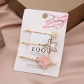 Elegant gold hair clip set with pink stars and white pearls on soft pink satin background - Pink Star Set