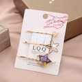 Detailed view of three-piece star hair clip set with pearls and acetate on display card - Blue Yellow Star Set