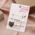 Detail of three heart hair clips with pearls and tortoise texture on a gift box - Black and Gray