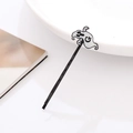 Detail shot of a minimalist Halloween ghost hair clip with G letter on white background - Black Ghost with Letter