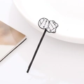 Detail of a black metal hair clip featuring a minimalist volleyball patterned decoration - Black Mummy