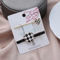 Checkerboard heart hair clip set with gold trim on decorative card display - Black and White (Black Clip)
