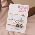 Three-piece gold hair clip set with rhinestone and pearl bow accents on silk background - Dark Grey