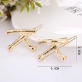 Set of two gold-plated alloy bamboo-style hair clips measuring 5.4cm by 2.8cm - Letter K