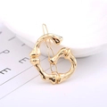 Golden letter G hair clip with bamboo texture finish for a sophisticated accessory look - Letter G