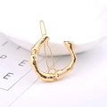 Elegant gold-plated alloy hair clip featuring a unique textured bamboo-style circular design - Letter C