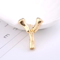 Golden alphabet Y brooch with bamboo texture finish on a minimalist white background - Letter Y