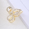 Detailed view of a gold-plated butterfly hair claw clip with sparkling white rhinestones - Bowknot Style - Rhinestone