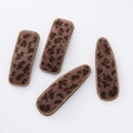 Close-up of leopard print hair clips with velvet texture and sparkling rhinestones - Dark Coffee Combo Style