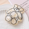 Close-up of marble pattern bear hair clip on an elegant white embossed ceramic plate - Off White