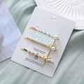 Set de tres pinzas para el cabello marinas con metal dorado, perlas y strass - Estilo Concha & Estrella de Mar