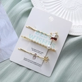 Détail d'un ensemble de trois barrettes dorées avec perles, étoile et astronaute - Thème Éléphant