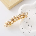 Detail of a golden bow hair clip featuring champagne teardrop crystals and alloy base - Gold Rhinestone Butterfly