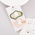 Detalle de las pinzas para el cabello onduladas rosa y verde en tarjeta de exhibición - Verde Nube Grande