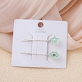 Detalle de horquillas estrella y nube verde menta en tarjeta de presentación - Estrella Nube Azul